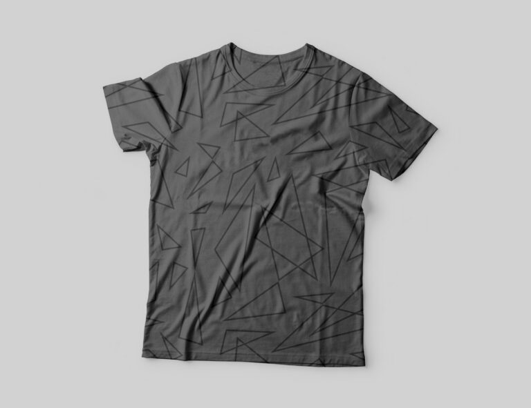 A dark gray t-shirt with a subtle, darker gray geometric triangle pattern, laid flat on a light gray surface.